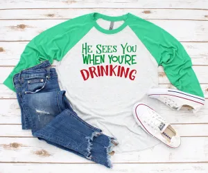 He Sees You When You're Drinking Christmas T-Shirt | X-Mas Raglan T Shirt | Funny Holiday 3/4 Sleeve Shirt